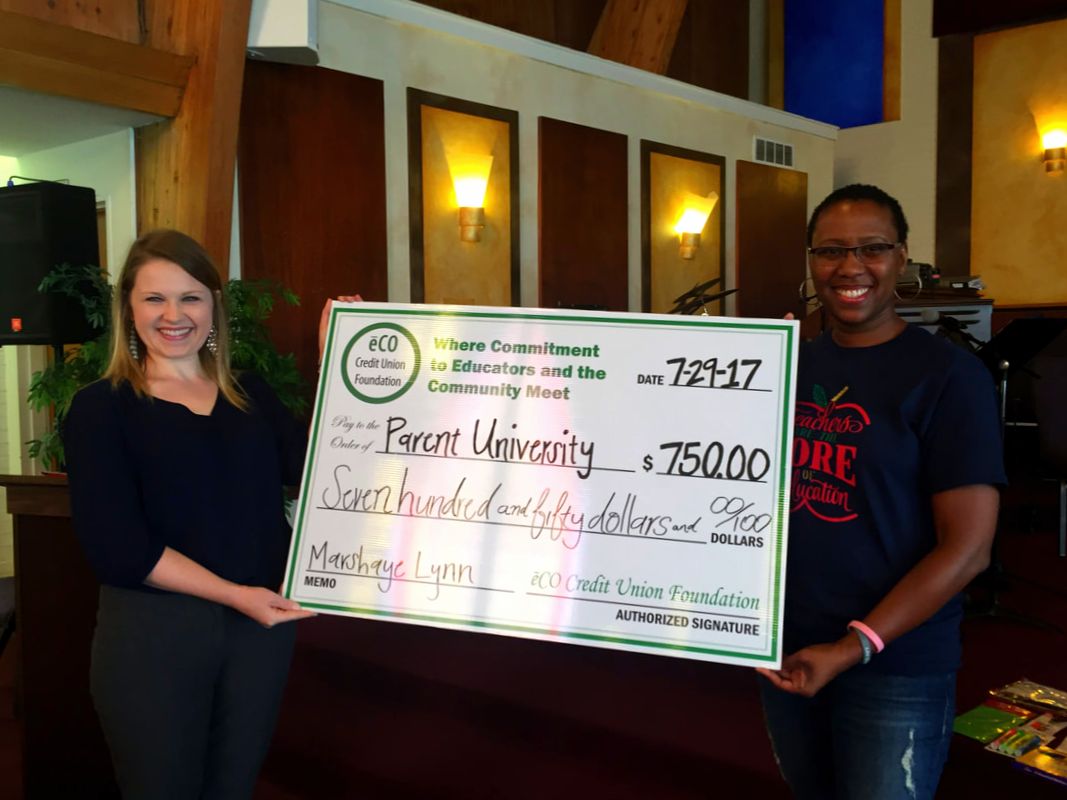 Picture of Georgia Hux presenting a check to Marshaye Lynn at Parent University