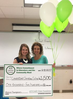 Georgia Hux presenting a $1,500 check to teacher Monica Youngblood